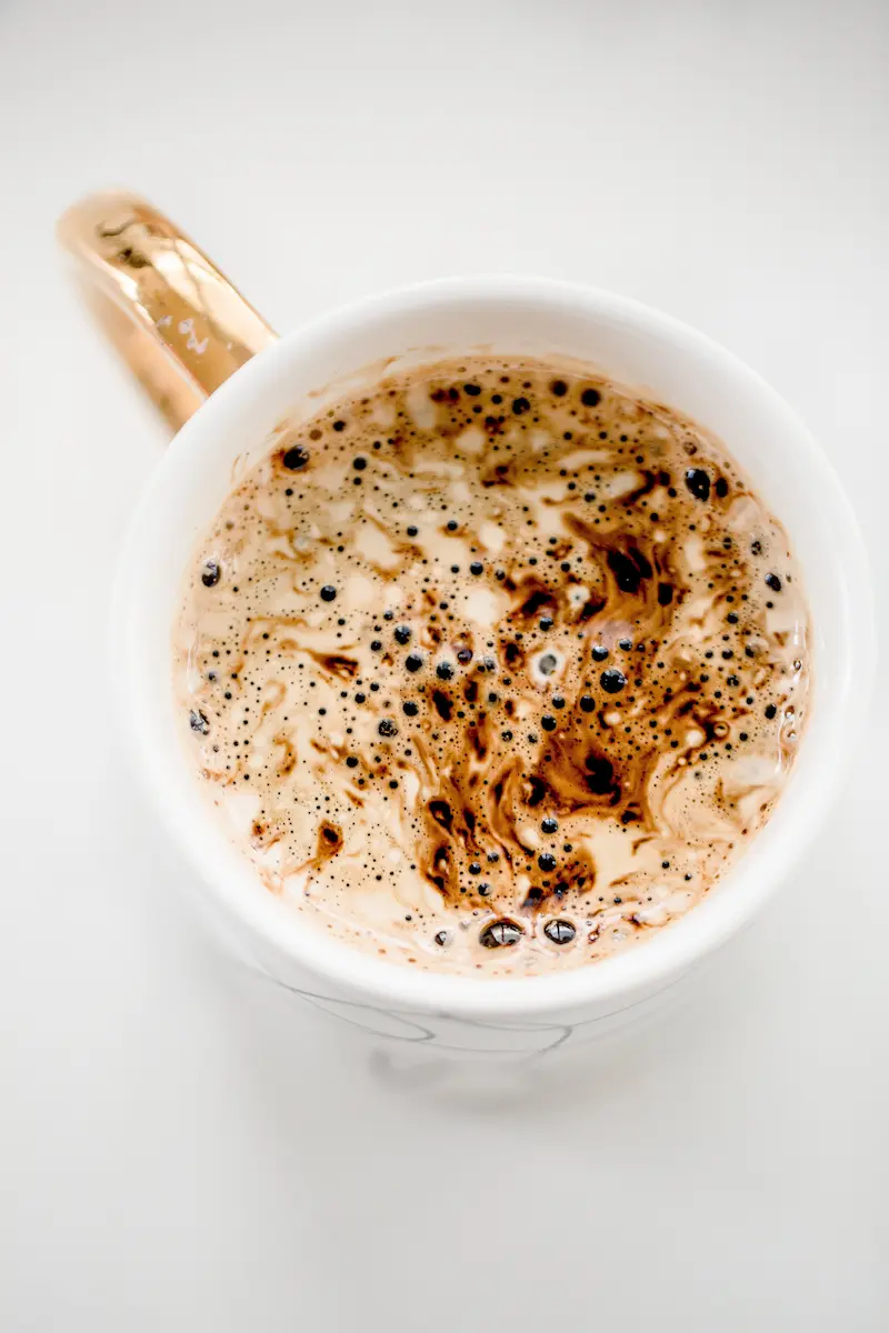 Top view of frothy hot chocolate in a mug.