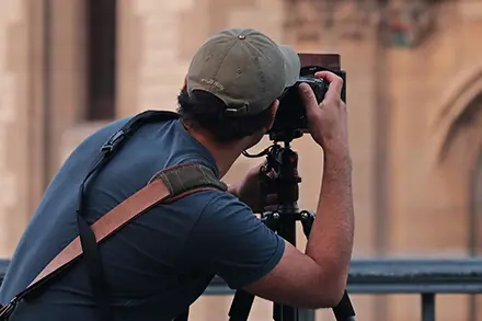 Man taking a photo of something in the distance